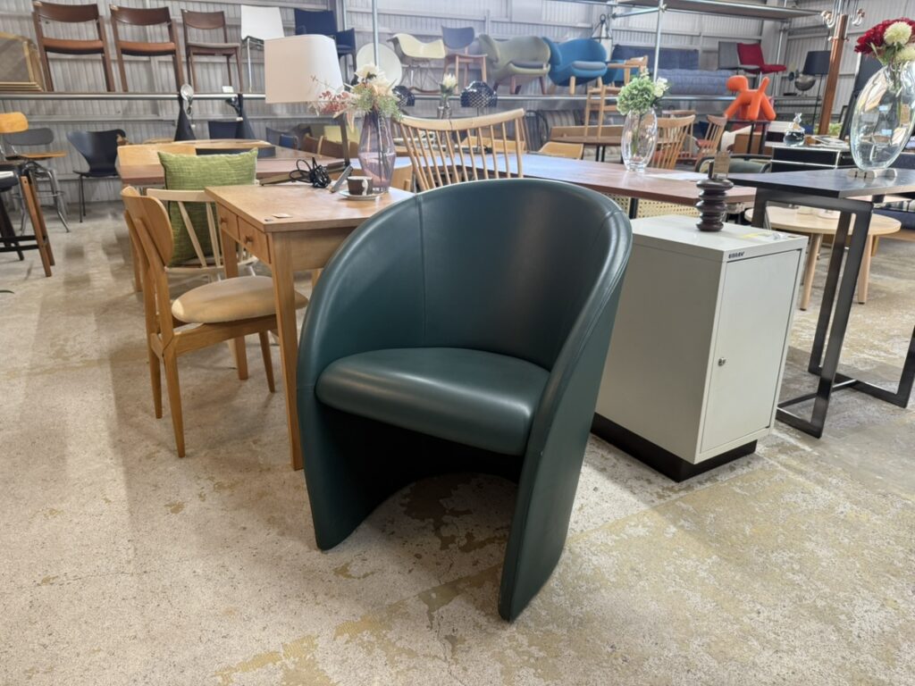 Poltrona Frau（ポルトローナ・フラウ）「Intervista（インターヴィスタ）」 正面画像　青みがかった深いグリーンのレザーを使用した包み込む形状のラウンジチェア、低重心で直線的なラインが際立つミニマルデザインソファ