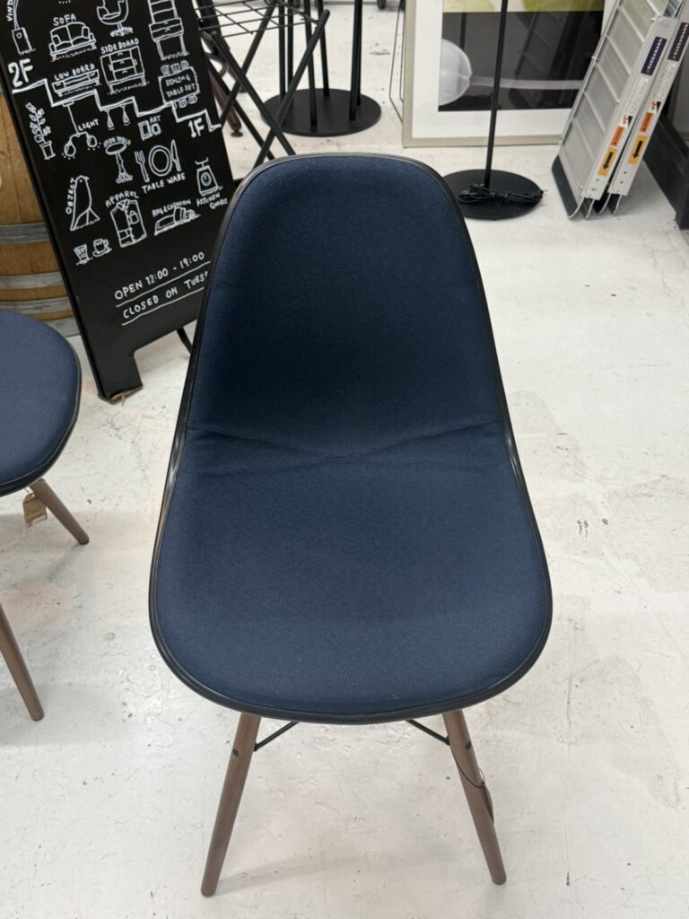 Herman Miller（ハーマンミラー）イームズ プラスチックシェルサイドチェア アップホルスター仕様。正面画像。ネイビーブルー系ファブリック張りと一体成形シェルの美しい曲線フォルムが際立つミッドセンチュリーチェア