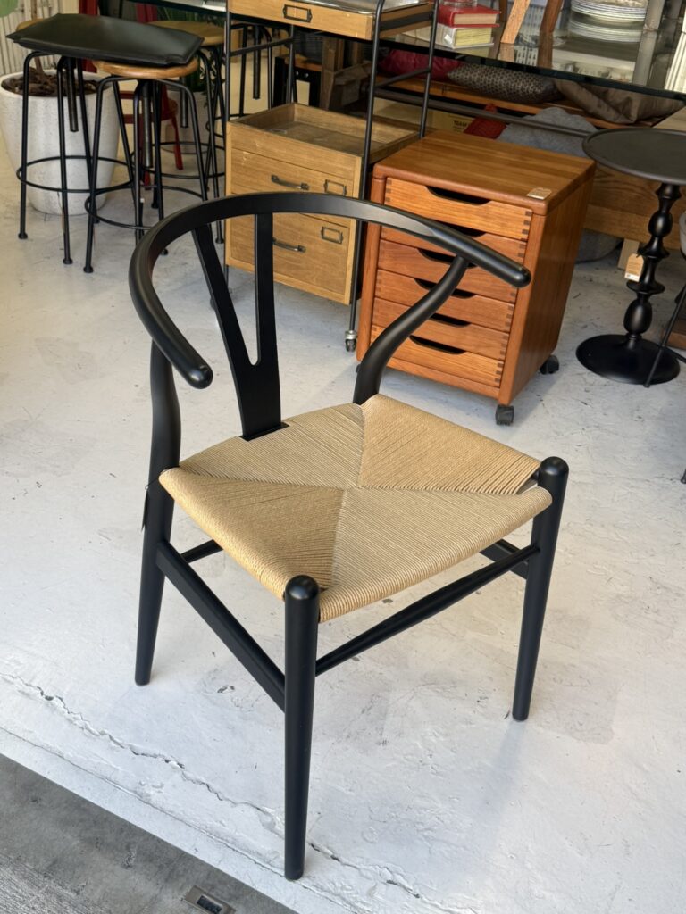 **Carl Hansen & Søn（カールハンセン&サン） CH24 Yチェア ダイニングチェア。** ビーチ材 × Soft Black（マットブラック）の組み合わせが、木の温もりと落ち着いた表情を演出。ペーパーコード座面と調和し、空間を引き締める北欧デザインの名作チェアです。
