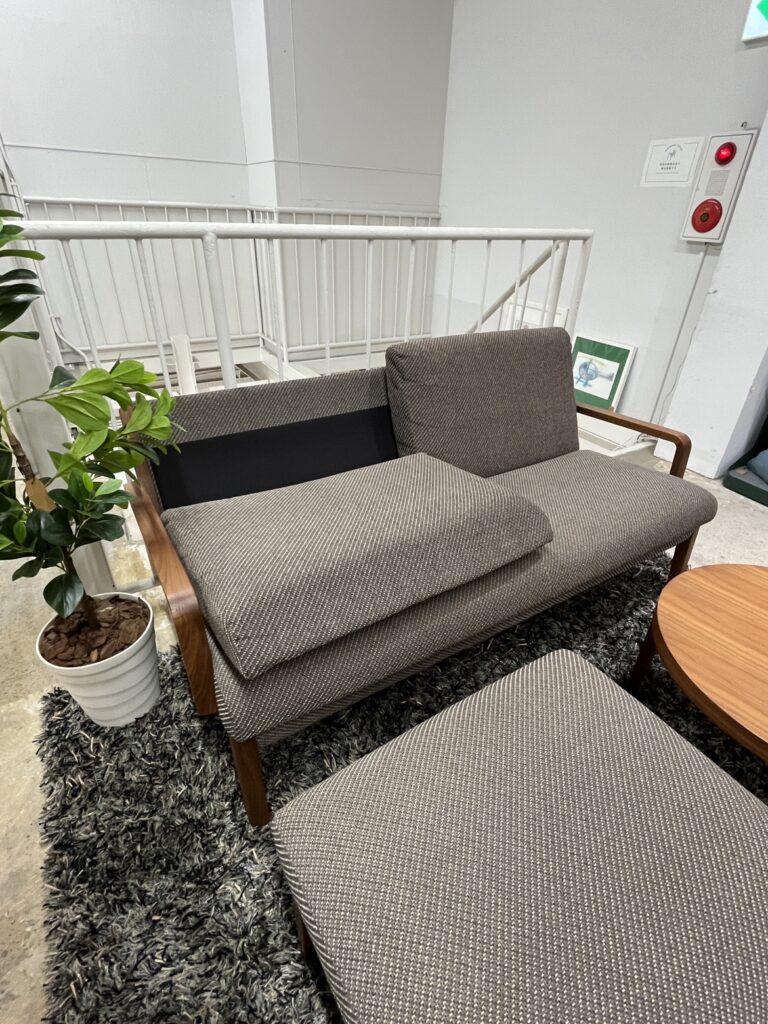 Karimoku（カリモク）WU45モデルの2人掛けロングソファ。背クッションを外すと見える黒い本体ベース部分も、生地の弛みがなく美しく仕上げられた丁寧な縫製と上質な品質が特徴。
